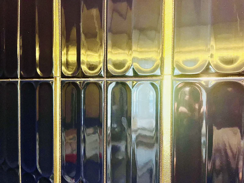 Glossy tile with brass inlay lines