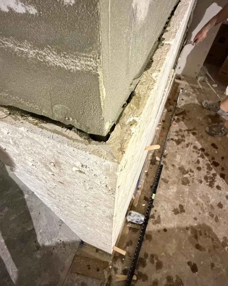 Natural stone column wrap with mitered corner in progress by Floors of Glory