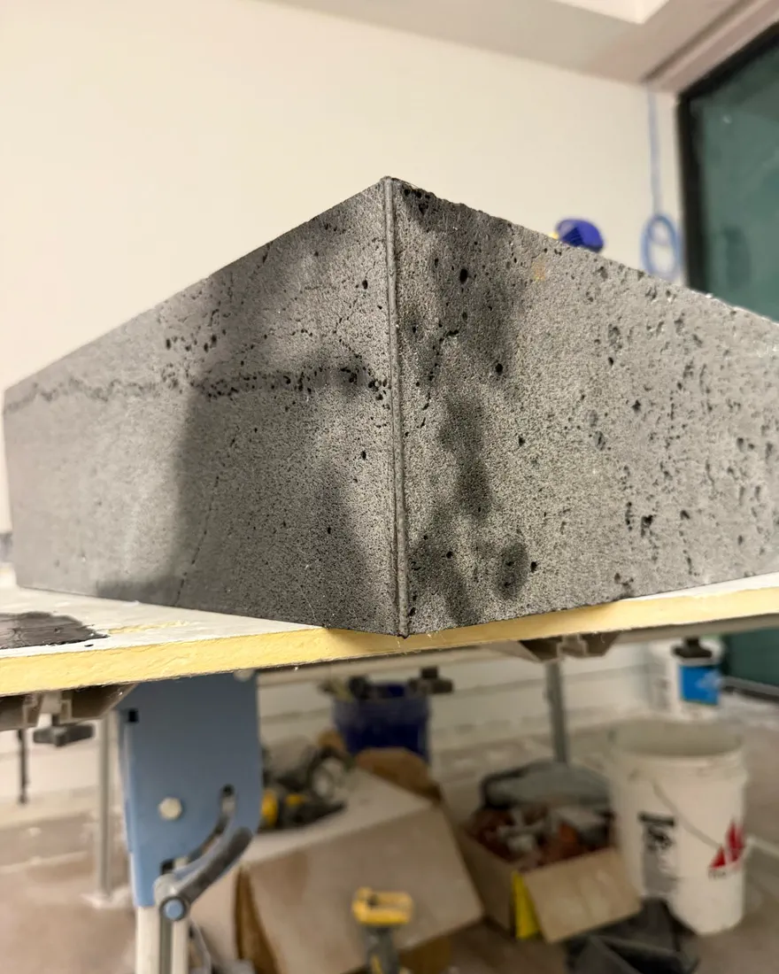 Lava stone corner mitered with epoxy, seam texture matching the stone